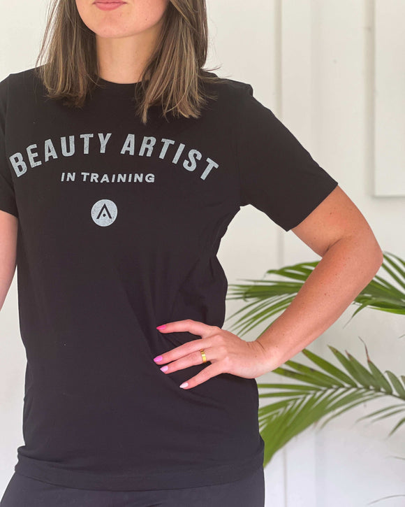 Woman wearing black Aveda Arts Beauty Artist In Training T-shirt, 100% cotton, Euro fit, stylish and comfortable, size up for relaxed fit