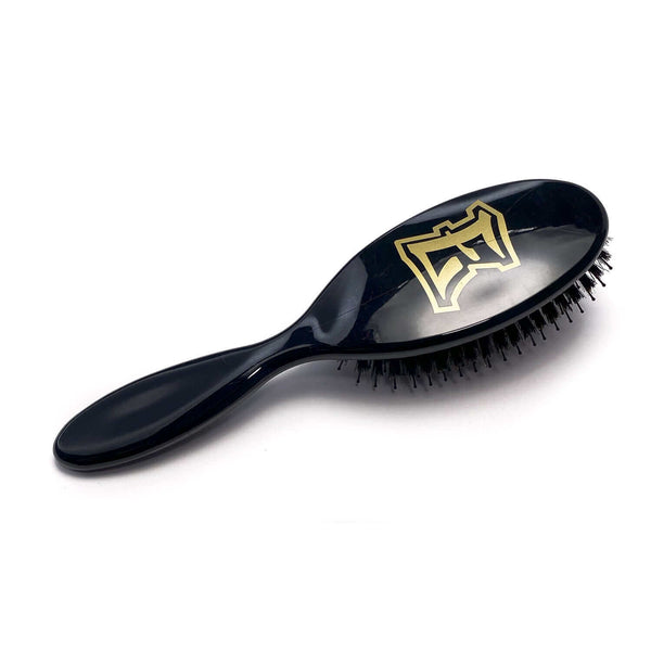 Black ELEVATE HAIR Cushion Brush by VESS with gold "E" logo, nylon and boar bristles for smooth, shiny hair and gentle scalp care