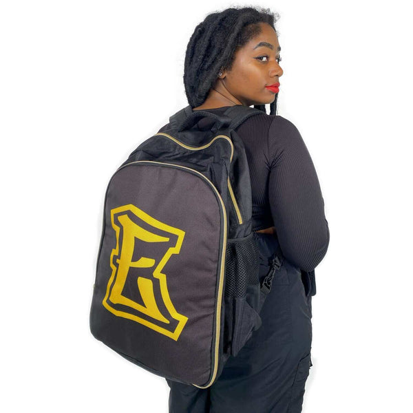 Person wearing E Stylist Barber Backpack with adjustable padded shoulder straps and large logo on back.
