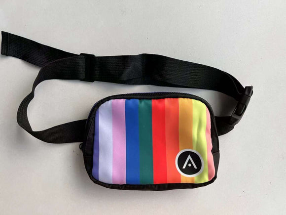 Unisex colorful Aveda Arts belt bag with a rainbow design and adjustable black strap.