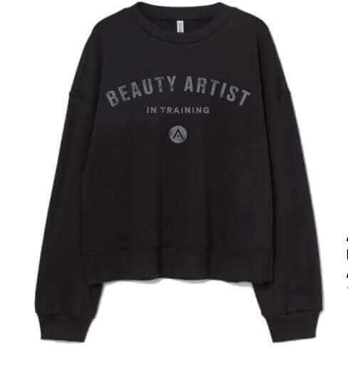 Black Aveda Arts "Beauty Artist In Training" fleece sweatshirt, made from 80/20% ring-spun cotton/poly blend.