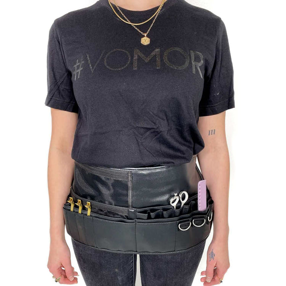 Stylist wearing Aveda Arts Tool Belt with scissors and clips, showcasing easy access for makeup artists, stylists, and barbers.