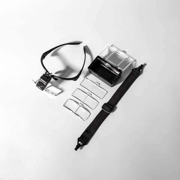 VoMor Lash Magnification Glasses with LED light, 5 interchangeable lenses, strap, and battery pack on display, reducing eye strain for lash artists.