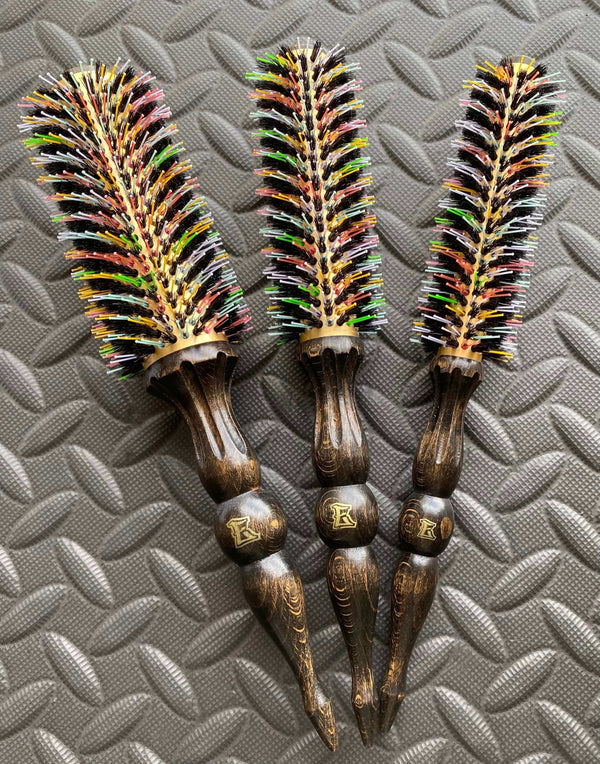 Rainbow-colored ElevateHair thermal brushes with heat-resistant nylon and natural boar bristles, featuring beechwood handles on a textured surface.