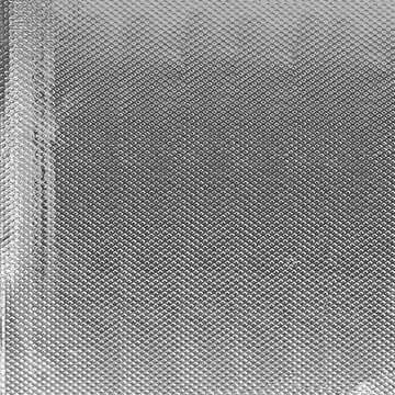 Close-up of Colortrak Foil Pop Up Max Width Silver hair foil sheet with textured surface, used for salon hair treatments.