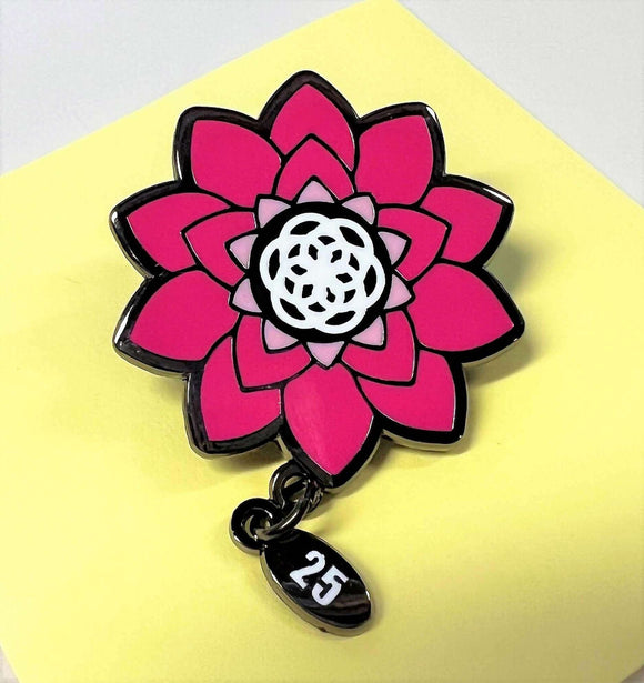 Serious Business 25th Anniversary Pin with vibrant blooming flower design