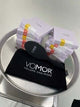 VoMor Detangling Brush with branded pouch and boxed products displayed on a metallic tray.