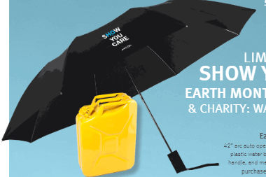 Aveda Show You Care umbrella with 42-inch arc, auto open feature, and water-repellent design, displayed with a yellow water container.