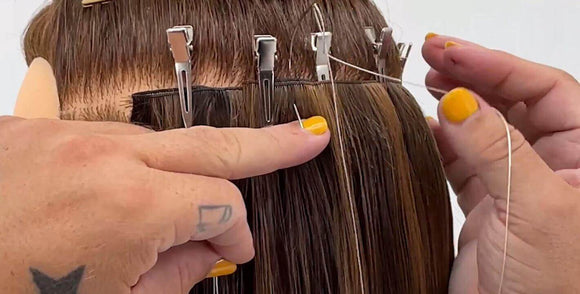 Hand tied marking clips holding hair securely while mapping hand tied wefts