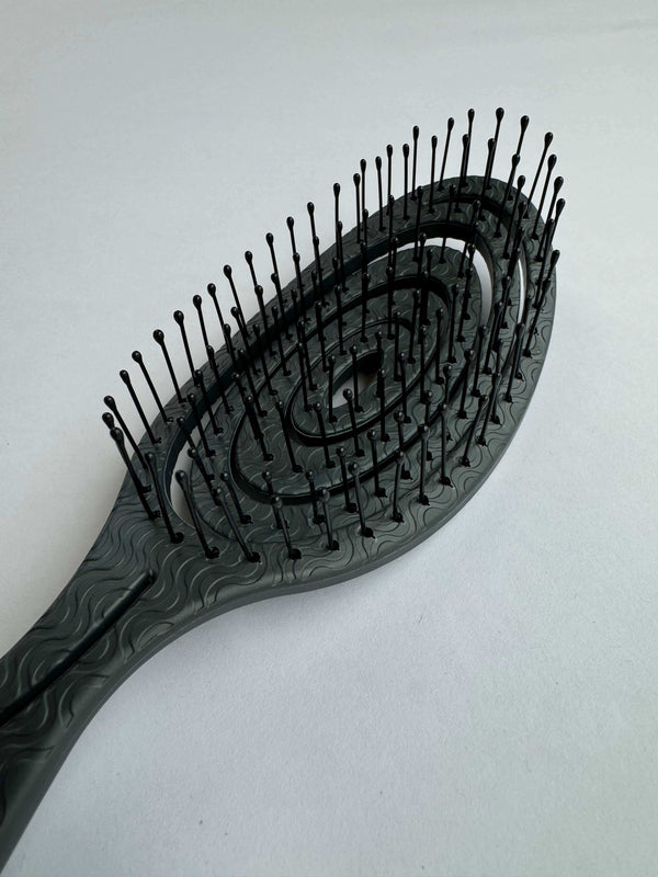 ELEVATE HAIR Detangling Brush by BASS with flexible nylon pins and 100% plant material handle designed for gentle detangling and style.